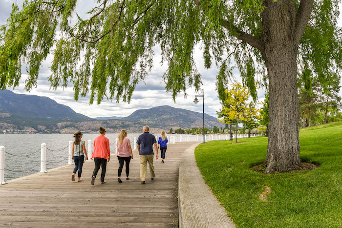 An image on the Cascadia Pacific Realty website, a Kelowna real estate agent. The image showcases a view of the Kelowna boardwalk