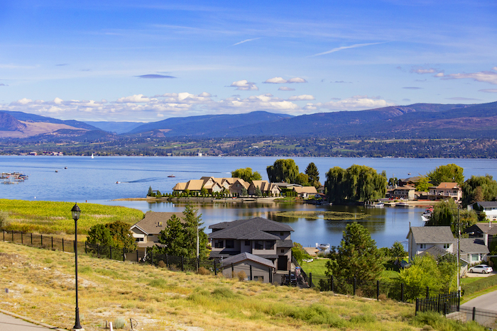 An image on the Cascadia Pacific Realty website, a Kelowna real estate agent. The image showcases a stunning view  of Kelowna waterfront 